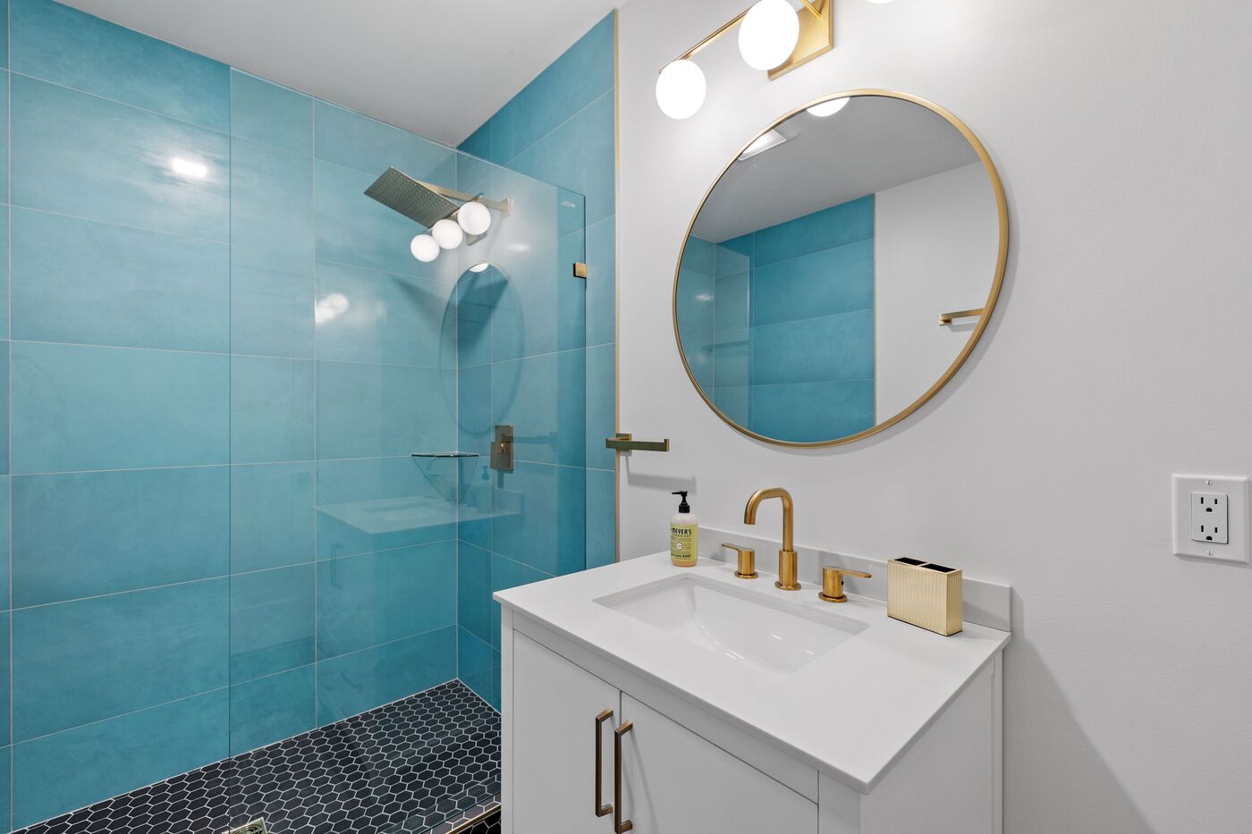 modern bathroom with a square showerhead and blue tiles